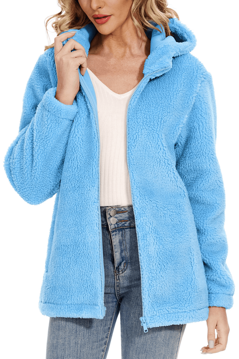 Woman wearing a stylish fluffy blue women's jacket with hood and zipper, SF0905, perfect for cozy warmth and fashionable look.